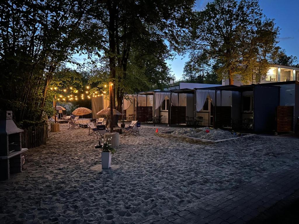 a courtyard with a group of tents with lights at Skorzęcin Przytulny Zakątek in Skorzęcin