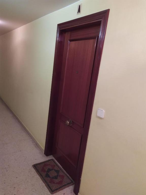 a wooden door in the corner of a room at La Niña in Tineo