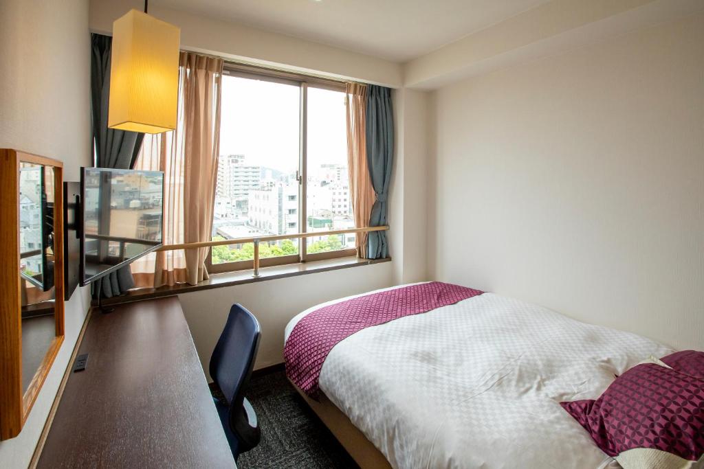 Postel nebo postele na pokoji v ubytování Hotel Claire Higasa