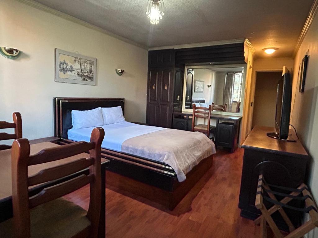 Postel nebo postele na pokoji v ubytování IÑAQUITO GOLD hostal
