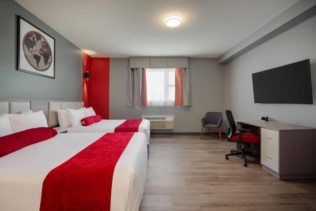 Postel nebo postele na pokoji v ubytování Ramada by Wyndham West Edmonton Hotel & Suites