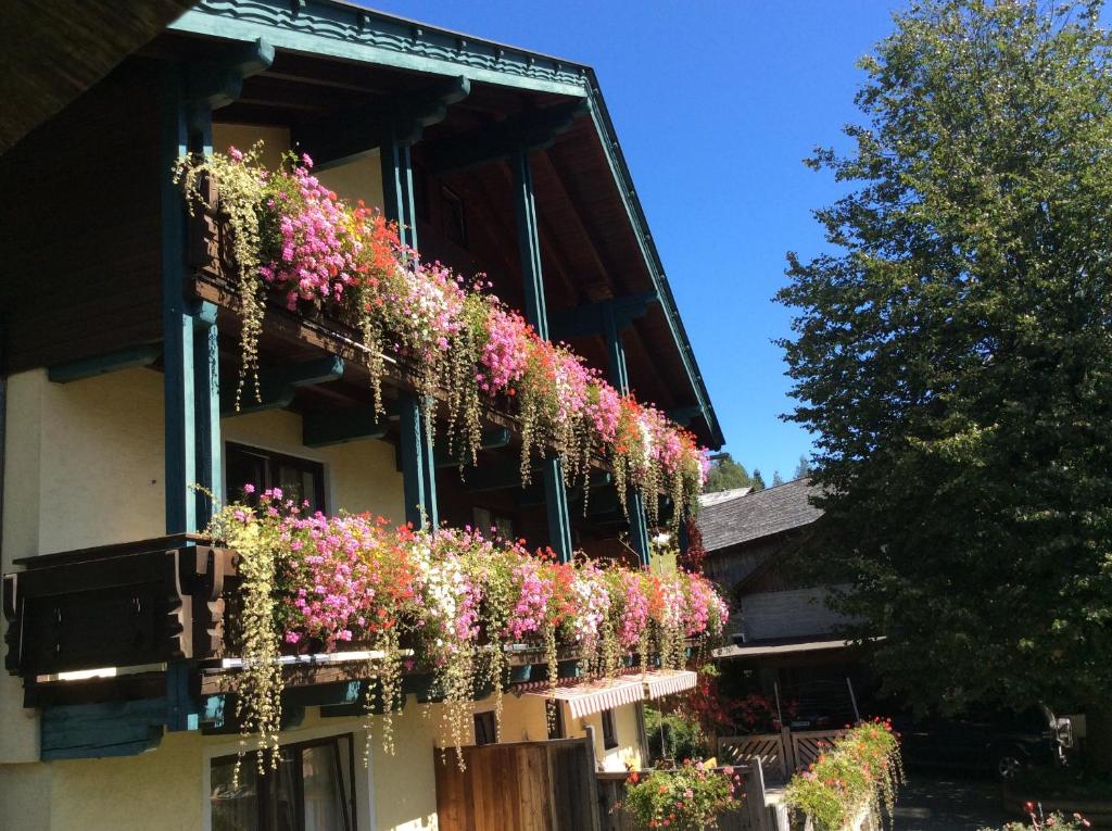 un edificio con flores a un lado. en Moosbauerhof en Bad Kleinkirchheim