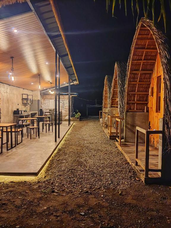 a room with a table and chairs and a building at Casita Agnes Private Resort in Boac