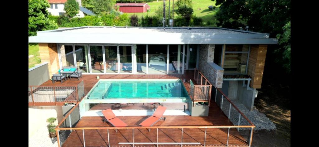a house with a swimming pool on a deck at Villaconcept57 in Abreschviller