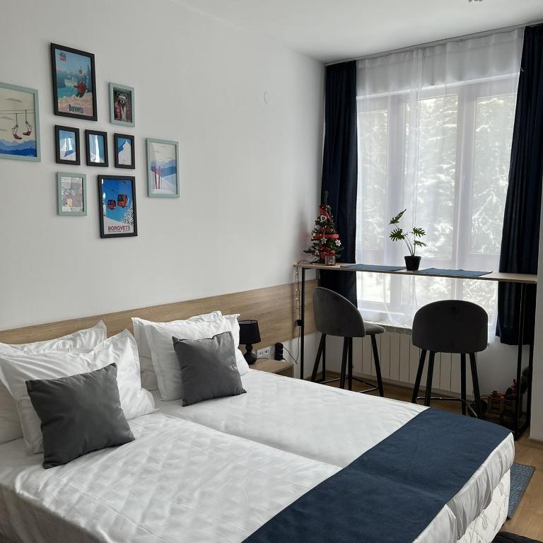 a bedroom with a bed and a glass table at Apartment for rest in Borovets in Borovets