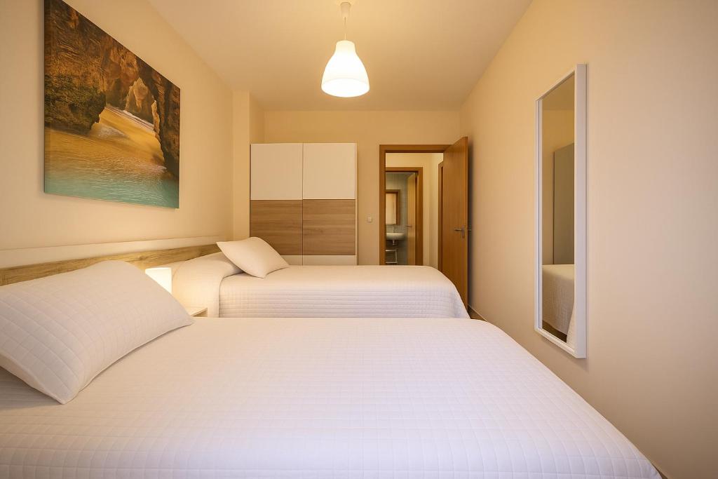 Postel nebo postele na pokoji v ubytování Area Suites