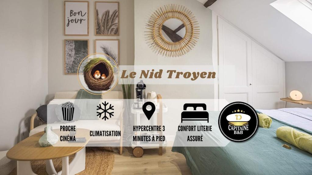 Cette chambre comprend un lit avec une table et une horloge. dans l'établissement Le Nid Troyen - Proche Hypercentre - 2 pers, à Troyes