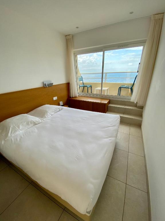Postel nebo postele na pokoji v ubytování Hotel L'ondine