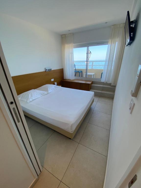Postel nebo postele na pokoji v ubytování Hotel L'ondine