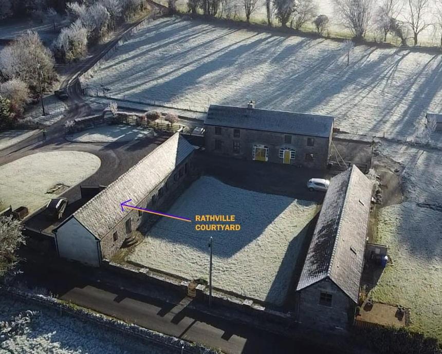 an aerial view of a building with a swimming pool at Stone Barn Cottage In Galway Countryside in Athenry