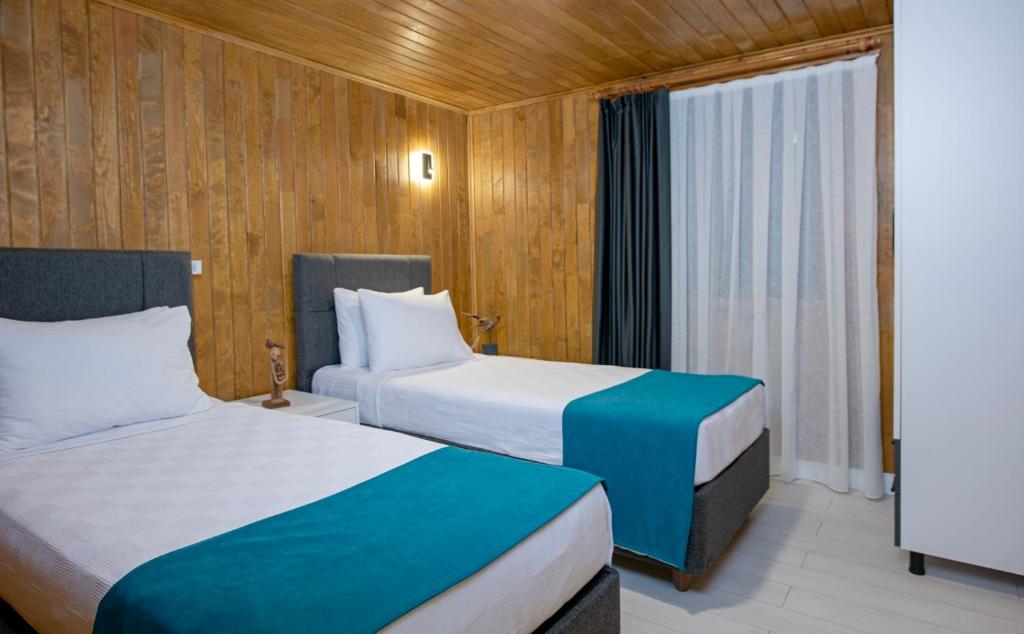 Postel nebo postele na pokoji v ubytování Yusalis Garden Hotel
