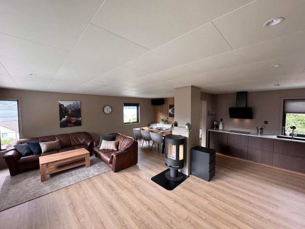 a living room with a couch and a table at House near Odda, Dronningstien and Trolltunga in Hovland
