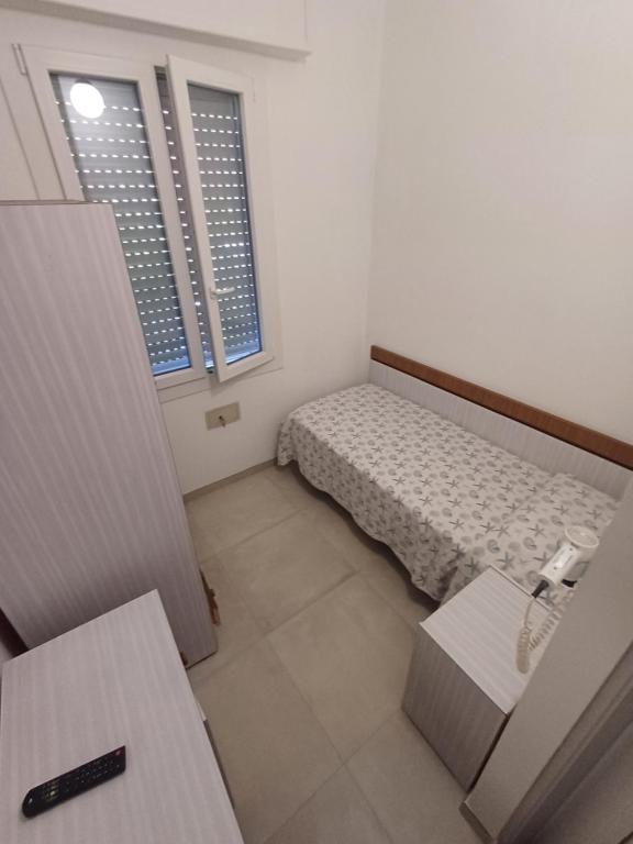 Postel nebo postele na pokoji v ubytování Hotel Flora