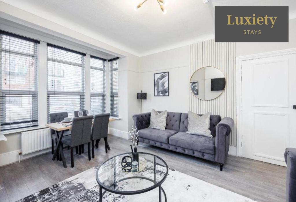 a living room with a couch and a table at Stylish & Charming 2BR - CITY CENTRE Nr High Street & C2C by Luxiety Stays in Southend-on-Sea