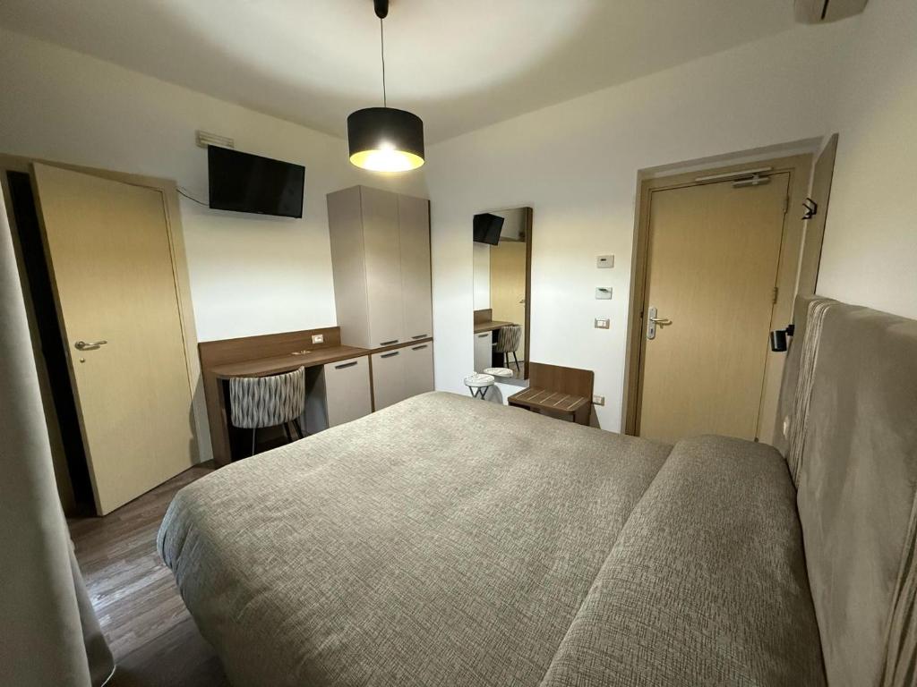 a bedroom with a bed and a desk in it at Hotel Miramare in Pineto