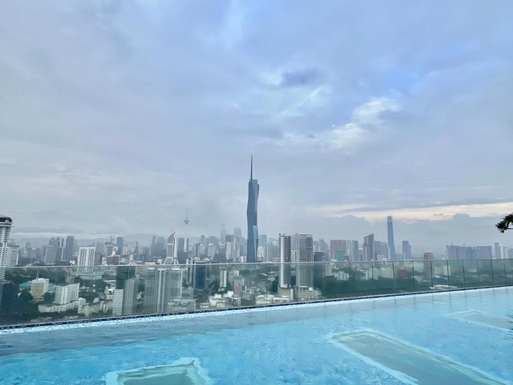 a swimming pool with a view of a city at Riveria City KL Sentral by Guestsupply in Kuala Lumpur