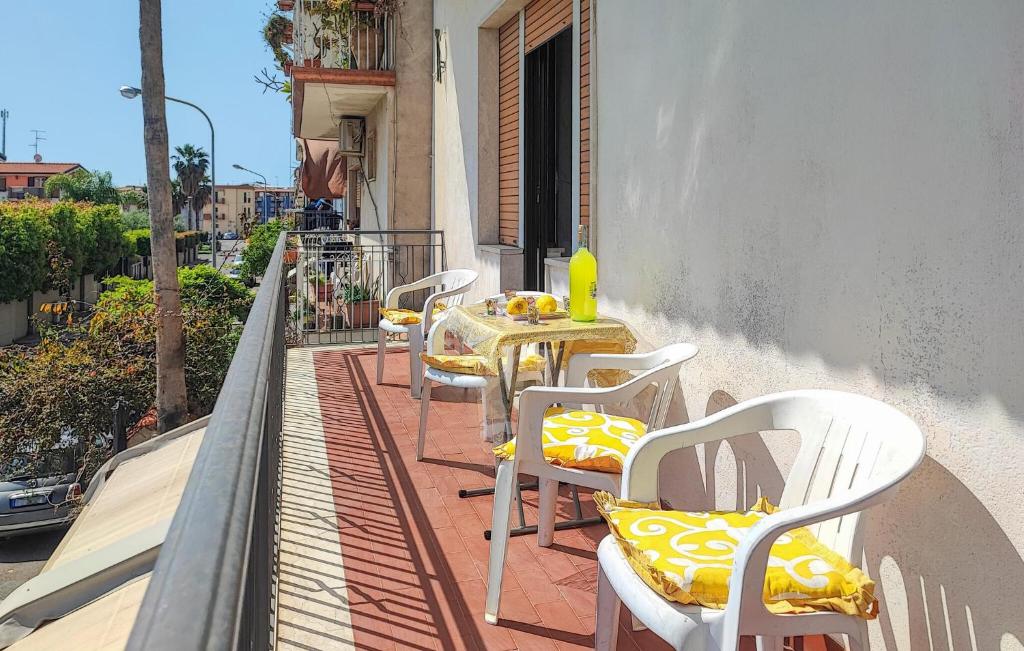 a row of tables and chairs on a balcony at Cozy Apartment In Chianchitta - Pallio in Schisò