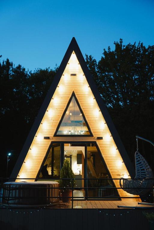 a house with a triangular roof with lights on it at Rustaveli 7 in Kutaisi