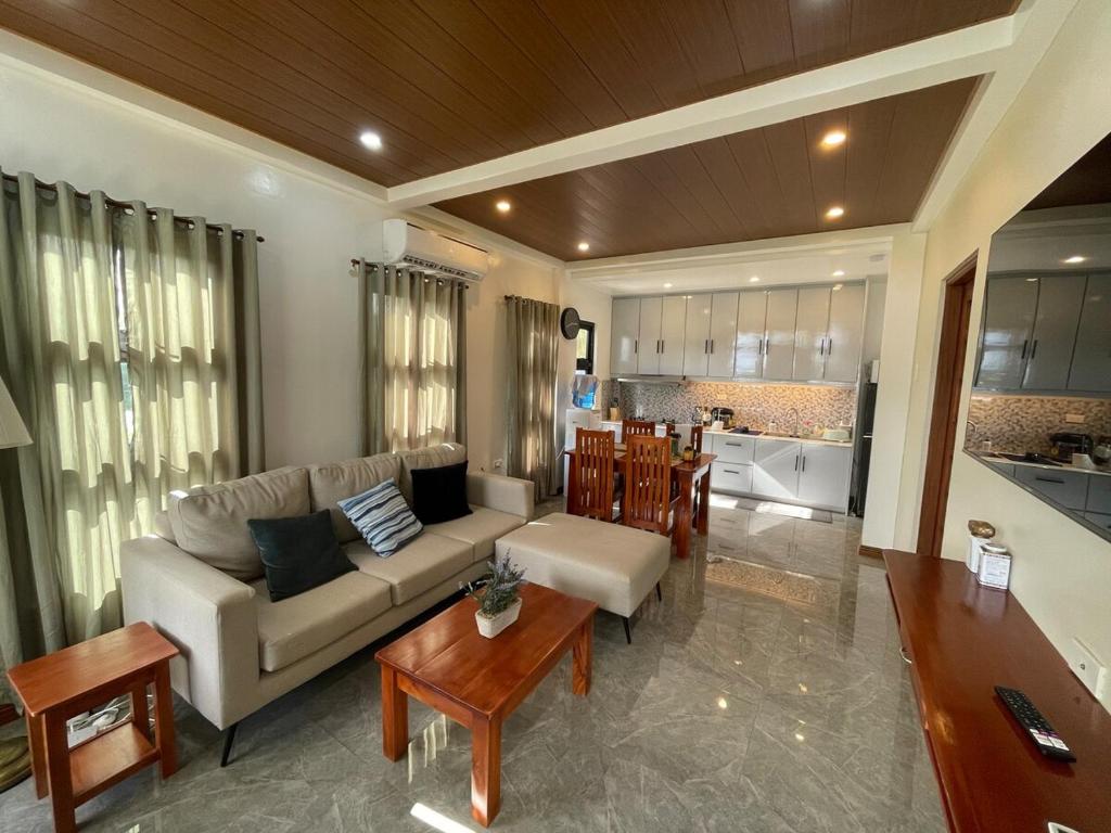 a living room with a couch and a table at JCPM Apartment Suite-3rd Floor in Santa Cruz