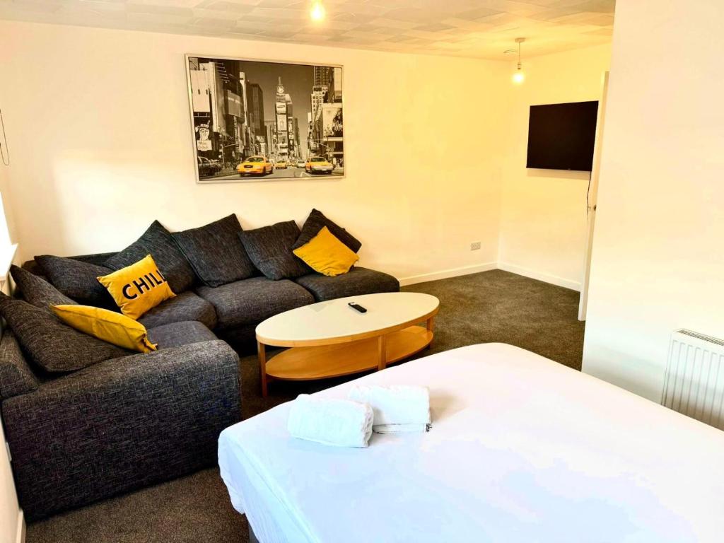 a living room with a couch and a table at 2-Bed City Apartment by Glasgow Green in Glasgow