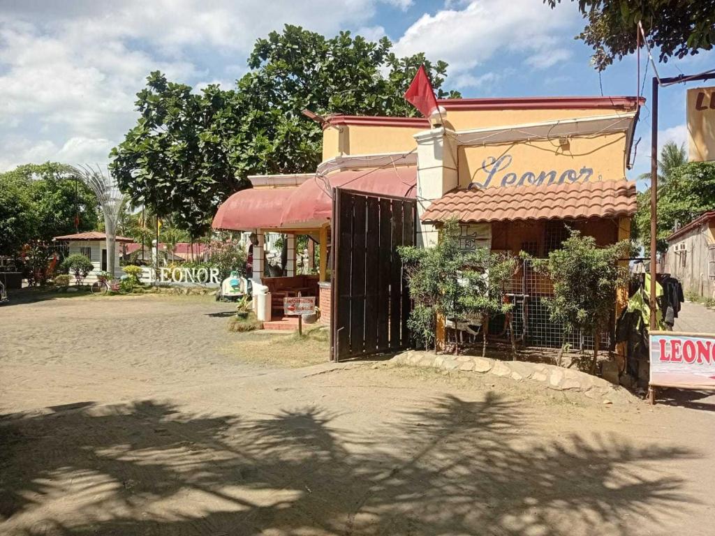 a building with a sign on the side of a street at Hotel O Leonor Beach and Resort in Tagaytay