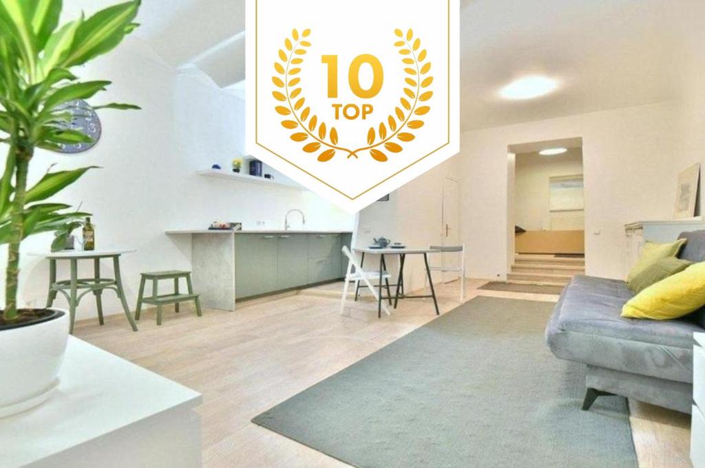 a living room with a couch and a table at Vilnius town square apartments SELF CHECK-IN 24h by H&H in Vilnius