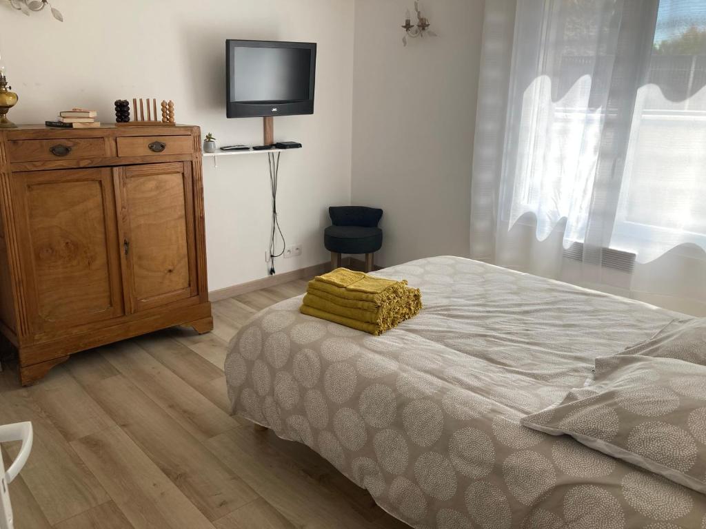 Postel nebo postele na pokoji v ubytování Chez Val et Phil