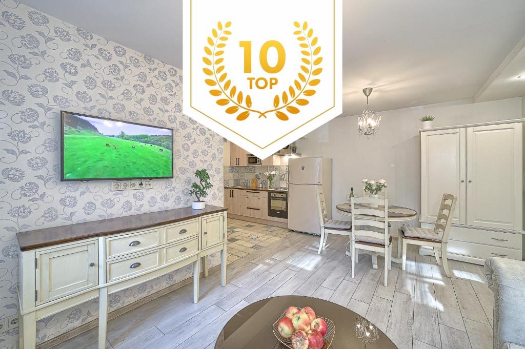 a living room with a tv and a table at Elegant apartment in Old town Vilnius SELF CHECK IN 24x7 by H&H in Vilnius