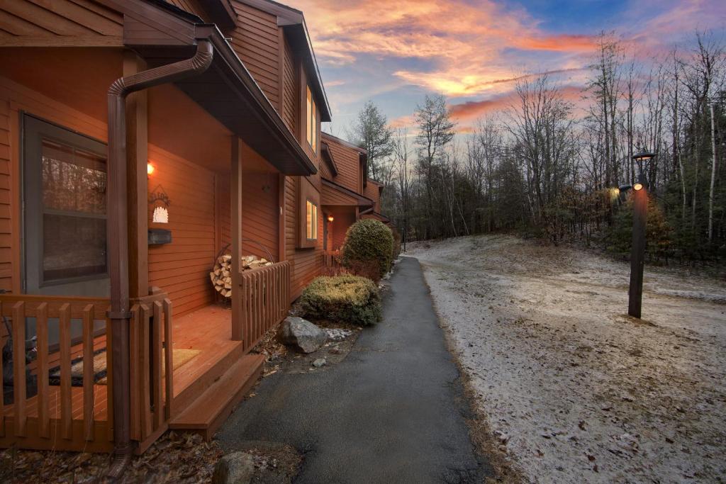 a wooden house with a porch and a driveway at Pine Knot 62H - Retreat with Private Play Area in North Creek
