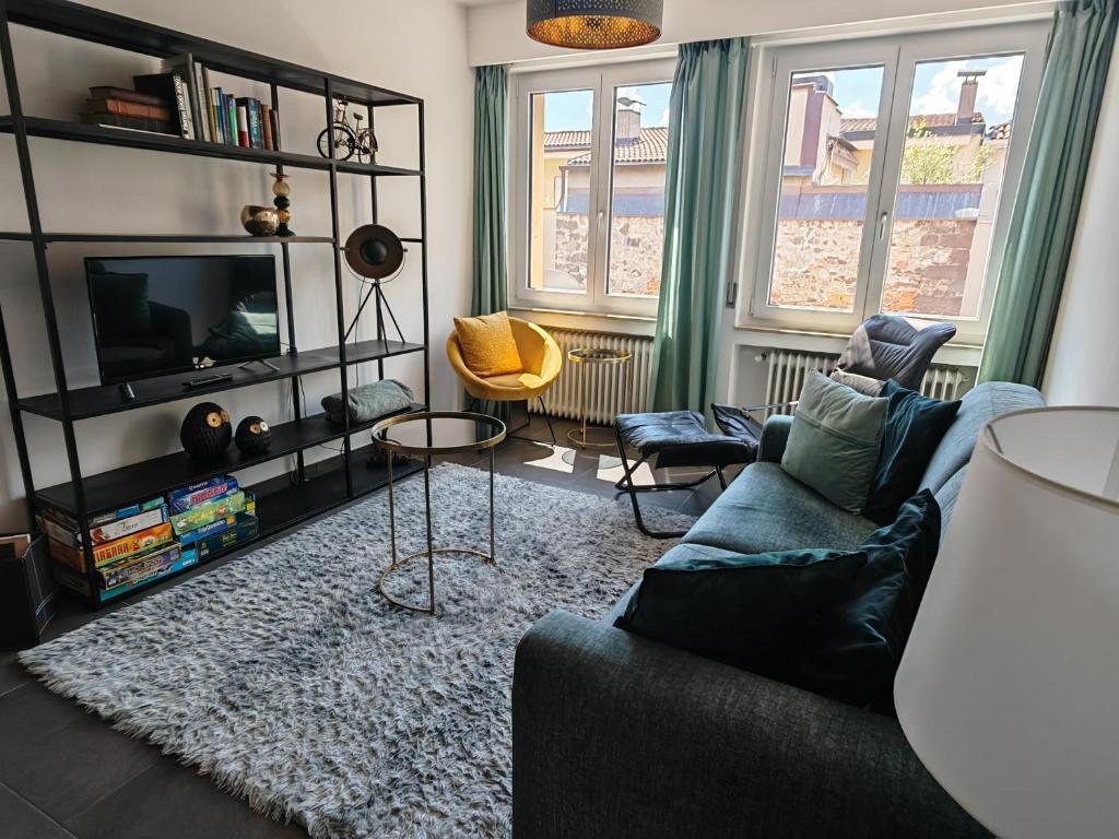 a living room with a couch and a tv at City Apartment 221 in Merano