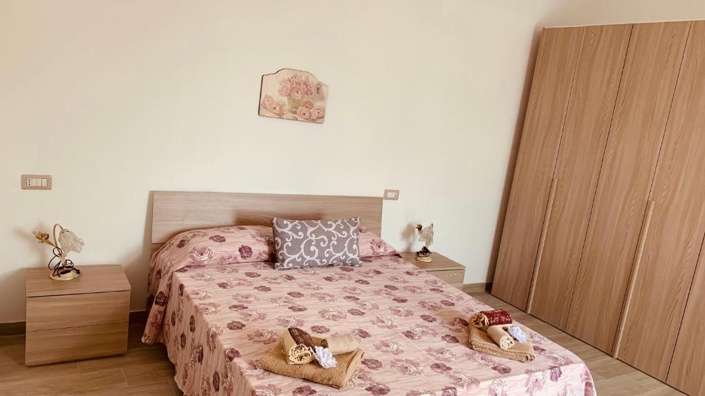 a bedroom with a bed and two night stands at Appartamenti Il Sole Parghelia in Parghelia