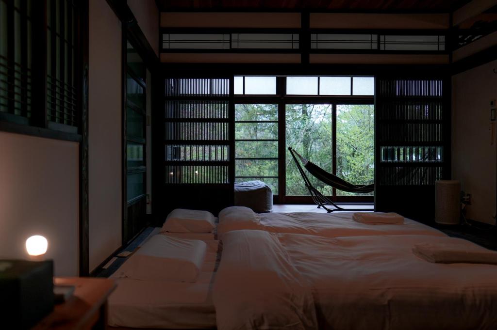 a room with a large bed with a large window at EXP Atelier in Fujinomiya