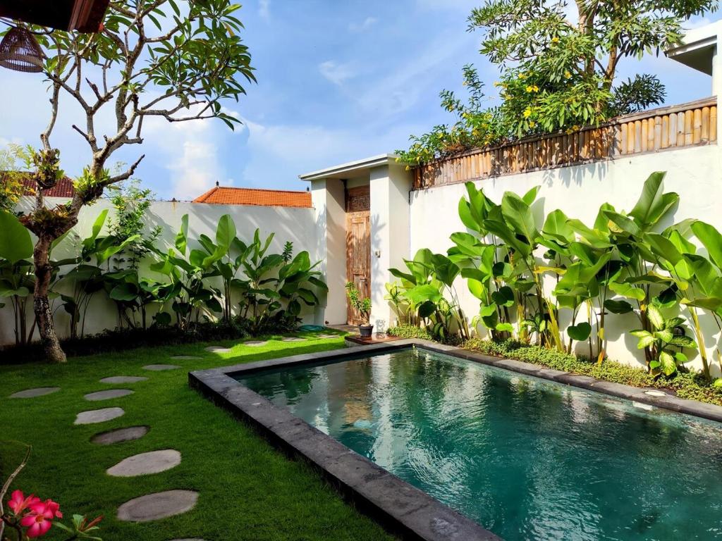 a swimming pool in the yard of a house at HiKina - Best Value Private Pool Villa in Canggu