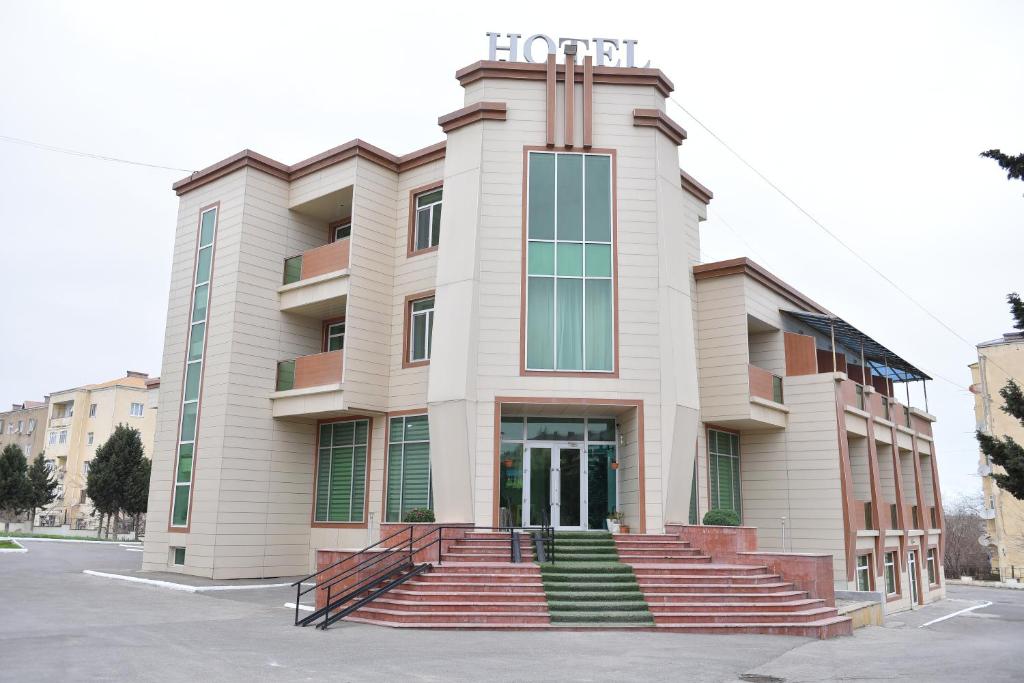 a building with stairs in front of it at Arena Hotel Sumgait in Sumqayıt