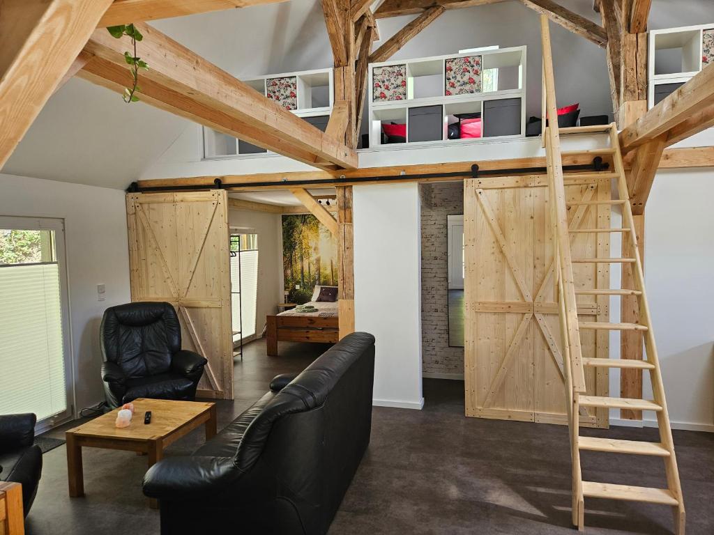 a room with a loft bed and a living room at Cottage am Michelsberg in Bad Münstereifel
