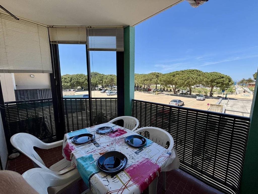 - une table sur un balcon avec vue sur la rue dans l'établissement Appartement climatisé à Argelès-sur-Mer avec Parking - 4 couchages - FR-1-388-52, à Argelès-sur-Mer