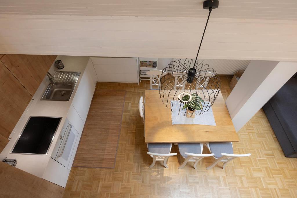 an overhead view of a kitchen with a table and chairs at Apartma Pehta in Kranjska Gora