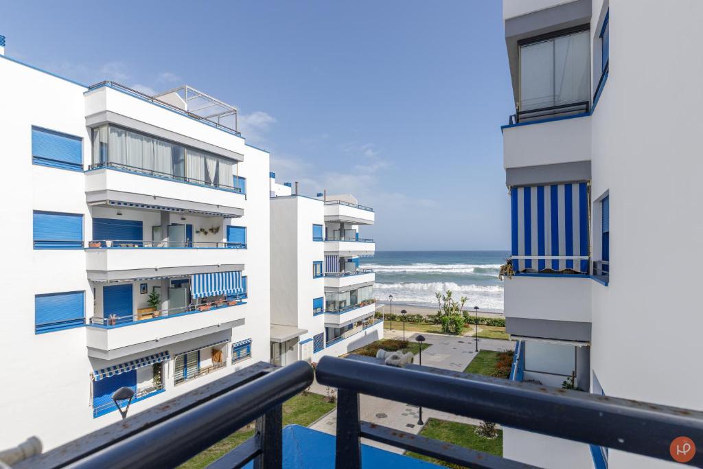 a view of the beach from the balcony of a building at Views of the Blue in Torrox