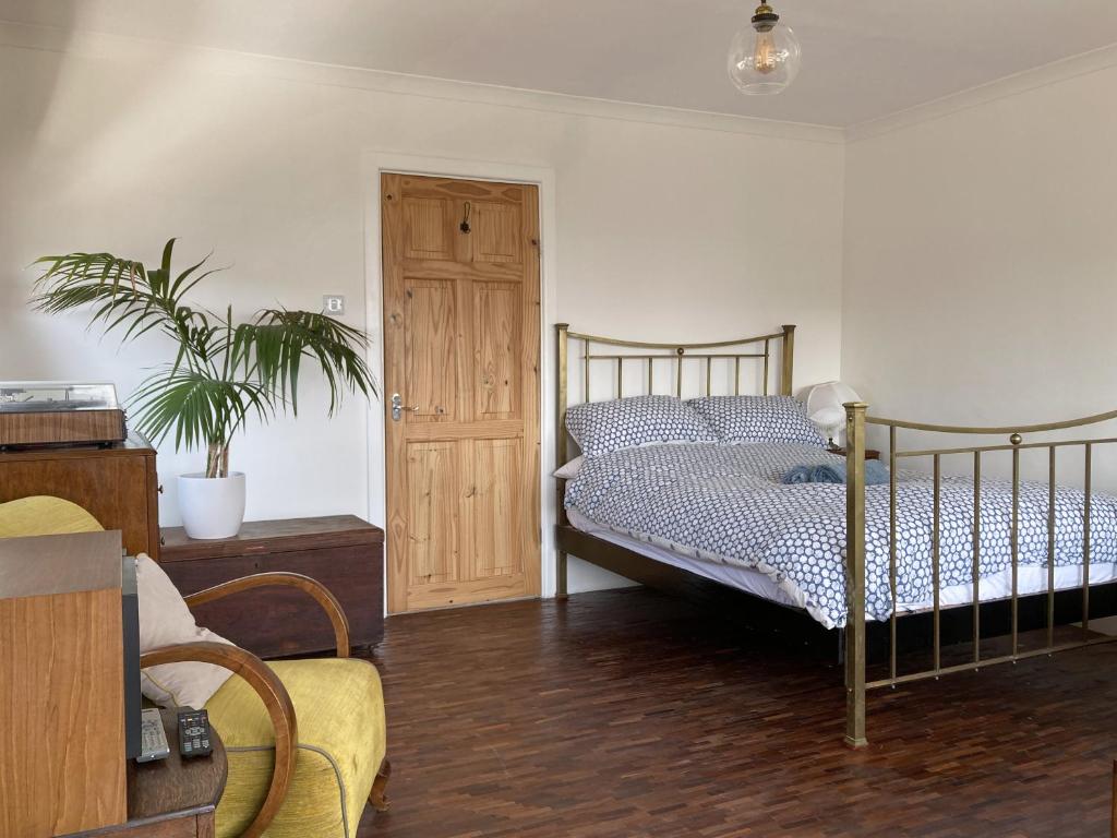a bedroom with a bed and a potted plant at Paradise Heights in West Bay