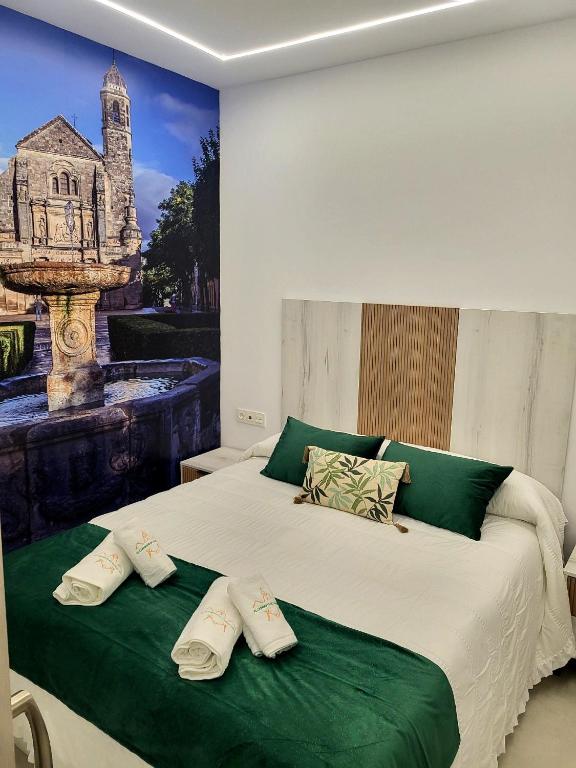 a bedroom with a bed with a picture of a church at El Capricho de Vandelvira in Úbeda