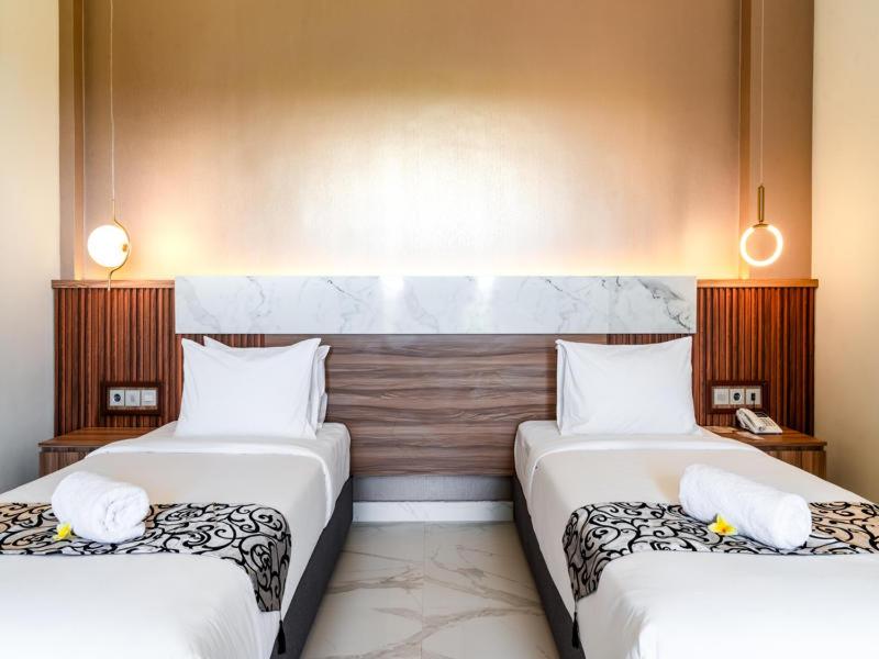 Postel nebo postele na pokoji v ubytování Ayers Hotel&Resto