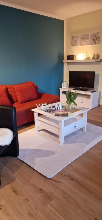 a living room with a couch and a coffee table at Ferienhaus Rumpelt in Kurort Gohrisch