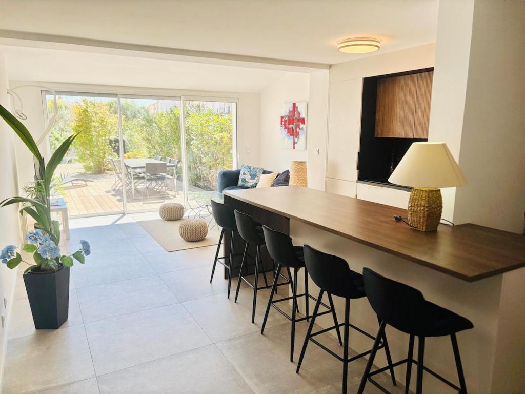 a kitchen with a large island with bar stools at Villa T4, île de la marina, parking in Cap d'Agde