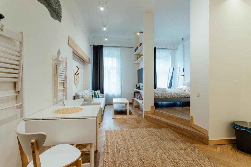 a living room with a couch and a bedroom at Apartmán CityPulse in Banská Štiavnica
