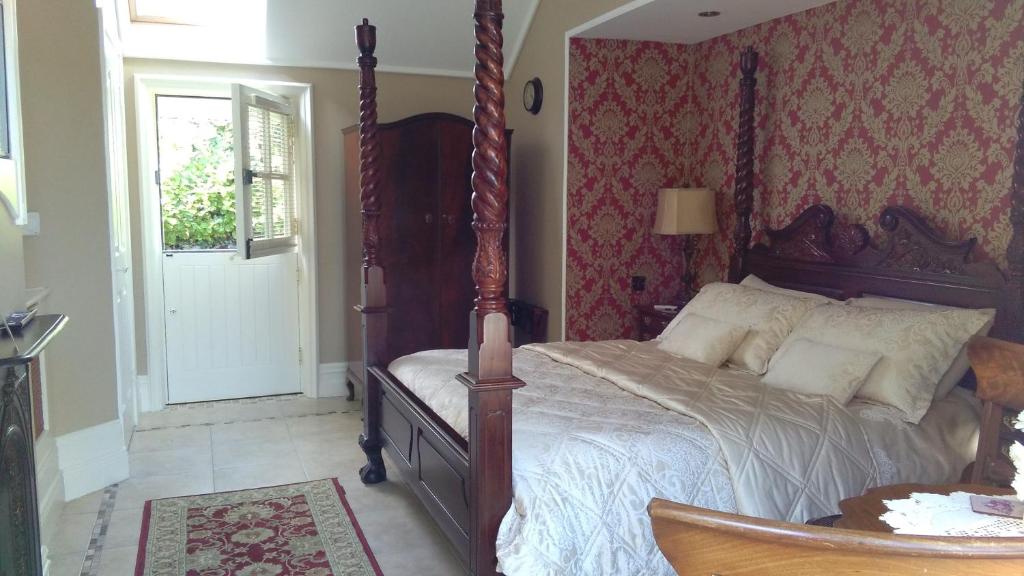 a bedroom with a bed and a door with a window at Riverside Lodge in Carlingford