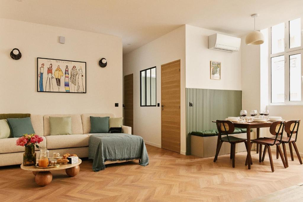 un salon avec un canapé et une table dans l'établissement Lavie Maison Central AC Hot Tub, à Paris