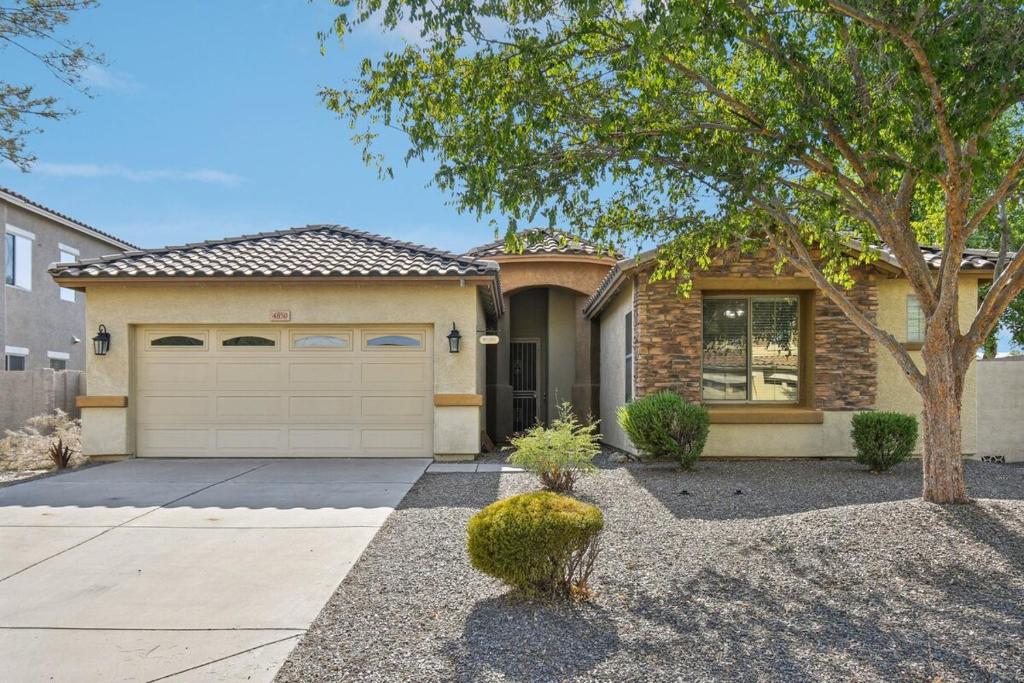 a house with a tree and a garage at Gilbert Getaway in Gilbert