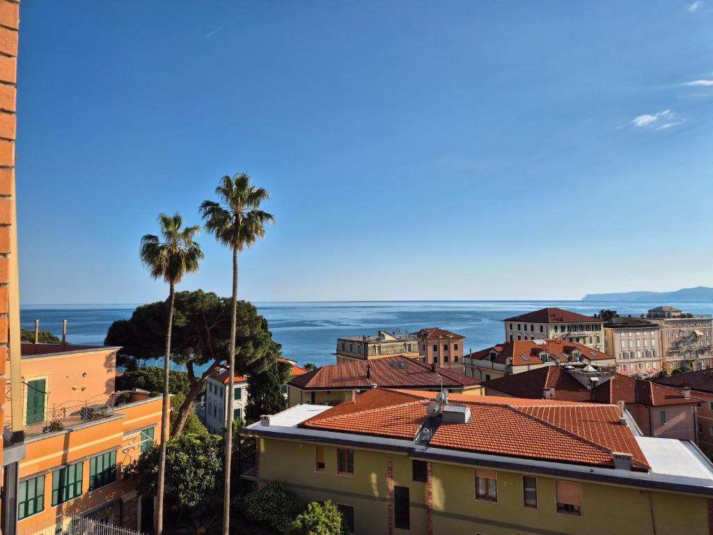 a view of a city with palm trees and the ocean at Appartamento La Casetta in Varazze