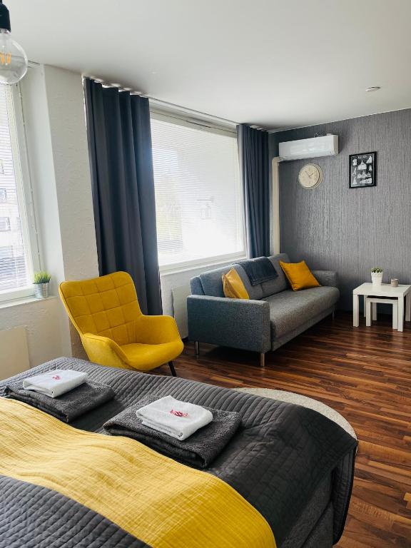 a living room with a bed and a couch at Compact apartment in Rauma in Rauma