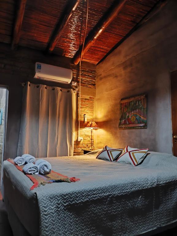a bedroom with a bed with towels on it at Complejo Volcanes de la Puna in Tinogasta